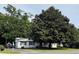 House exterior featuring a white single story home with large tree at 704 9Th Ave. S, Myrtle Beach, SC 29577