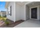 A charming entrance with detailed black door and landscaped mulched garden to the side at 1061 Kinness Dr., Conway, SC 29527