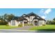 Stunning two-story home boasts a manicured lawn, arched entry, and multi-car garage at 372 Chamberlin Rd., Myrtle Beach, SC 29588