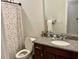 Bright bathroom with a granite countertop, seashell shower curtain, and a modern vanity at 408 Stevia Ct., Conway, SC 29526