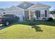 Well-maintained home with a lush green lawn and a dark pickup truck parked in the driveway at 408 Stevia Ct., Conway, SC 29526