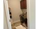 Well-lit laundry room featuring modern appliances, ample cabinet space, and neutral tile floors at 408 Stevia Ct., Conway, SC 29526