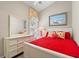 Bedroom with red bedding, white dresser, and coastal art at 6001 - 8050 South Kings Hwy., Myrtle Beach, SC 29575