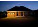 Exterior photo of the rear of the home with an outdoor kitchen and a well-maintained lawn at 9048 Abingdon Dr., Myrtle Beach, SC 29579