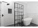 Modern bathroom featuring black shower with subway tile, a free-standing tub and grey floors at 9048 Abingdon Dr., Myrtle Beach, SC 29579