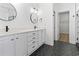 A renovated bathroom featuring a white vanity, a large mirror and modern fixtures at 9048 Abingdon Dr., Myrtle Beach, SC 29579