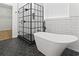 A modern bathroom features a black-framed glass shower and a freestanding tub at 9048 Abingdon Dr., Myrtle Beach, SC 29579