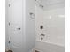 Bright bathroom features a shower and tub combination with white tiling and fixtures at 9048 Abingdon Dr., Myrtle Beach, SC 29579