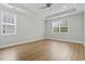 Spacious bedroom featuring tray ceilings, a ceiling fan and two large windows for natural light at 9048 Abingdon Dr., Myrtle Beach, SC 29579