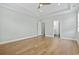 Large bedroom featuring a ceiling fan, hardwood floors, and access to the bathroom at 9048 Abingdon Dr., Myrtle Beach, SC 29579