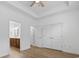 A spacious bedroom with a ceiling fan, wood floors, and access to the bathroom and walk-in closet at 9048 Abingdon Dr., Myrtle Beach, SC 29579