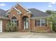 Charming brick home with a welcoming entrance, arched windows, and lush landscaping at 9048 Abingdon Dr., Myrtle Beach, SC 29579