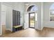 An inviting foyer with light wood floors, coat rack, and an arched window above the front door at 9048 Abingdon Dr., Myrtle Beach, SC 29579