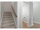 Hallway with access to a bathroom, stairs to an upper level, and plank flooring at 9048 Abingdon Dr., Myrtle Beach, SC 29579