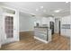 Open floor plan showing kitchen with wooden breakfast bar, white cabinets, and stainless appliances at 9048 Abingdon Dr., Myrtle Beach, SC 29579