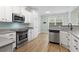 Kitchen and eat-in area with gray counters, stainless steel appliances, and white cabinets at 9048 Abingdon Dr., Myrtle Beach, SC 29579