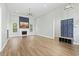 A spacious living room with a fireplace, tall ceilings, and plenty of natural light from the windows at 9048 Abingdon Dr., Myrtle Beach, SC 29579