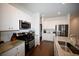 Modern kitchen with white cabinets, granite island, and stainless steel appliances at 149 Cypress Tree Loop, Longs, SC 29568