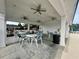 Covered patio area with tables and chairs near the pool at 149 Cypress Tree Loop, Longs, SC 29568