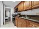 Functional kitchen with wooden cabinets, granite countertops, and stainless steel sink at 1501 S Ocean Blvd. # 240, Myrtle Beach, SC 29577