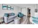 Inviting living room with a gray sofa, blue armchair, and modern decor, offering a cozy space at 1501 S Ocean Blvd. # 240, Myrtle Beach, SC 29577