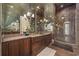 Lavish bathroom featuring a mirrored vanity, chandelier lighting, and a glass walk-in shower at 1549 Serena Dr., Myrtle Beach, SC 29579