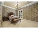 A traditionally styled bedroom features decorative wallpaper, a chandelier, and access to the outdoors at 1549 Serena Dr., Myrtle Beach, SC 29579