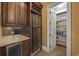 Butler's pantry featuring custom cabinetry, wine refrigerator, and convenient access to storage at 1549 Serena Dr., Myrtle Beach, SC 29579