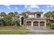 Stately Mediterranean home boasts a tile roof, a three-car garage, and lush landscaping at 1549 Serena Dr., Myrtle Beach, SC 29579