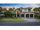 Stately Mediterranean home boasts a tile roof, a three-car garage, and lush landscaping at 1549 Serena Dr., Myrtle Beach, SC 29579