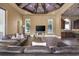 Comfortable living room showcases a coffered ceiling, plush leather sofa, and backyard view at 1549 Serena Dr., Myrtle Beach, SC 29579