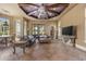 Spacious living room features a coffered ceiling, leather sofas, and expansive windows at 1549 Serena Dr., Myrtle Beach, SC 29579