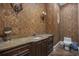 Elegant powder room featuring custom wallpaper, vanity and contemporary lighting fixtures at 1549 Serena Dr., Myrtle Beach, SC 29579