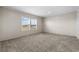 Spacious carpeted bedroom with large window and neutral walls at 215 Eva Dr., Loris, SC 29569