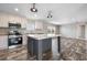 Open concept kitchen with island and stainless steel appliances at 215 Eva Dr., Loris, SC 29569