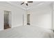 This bedroom features a ceiling fan, a window, light gray carpet, a trey ceiling and door at 7913 E Highway 19, Loris, SC 29569