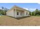 A well-maintained single-story house with beige siding, white trim, and a manicured lawn on a sunny day at 7913 E Highway 19, Loris, SC 29569