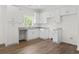 Bright kitchen featuring granite counters, white cabinets, and stainless steel sink at 7913 E Highway 19, Loris, SC 29569