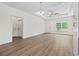 Open-concept room with hardwood floors, a ceiling fan, and ample natural light at 7913 E Highway 19, Loris, SC 29569