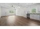 Open-concept living room and kitchen area featuring hardwood floors and ample natural light at 7913 E Highway 19, Loris, SC 29569