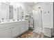 Bright bathroom featuring a white vanity, framed mirror, and a glass-enclosed shower with tile surround at 149 Harmony Ln., Myrtle Beach, SC 29588