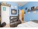 Blue bedroom with a dark leather chair and doorway to an adjacent yellow room at 149 Harmony Ln., Myrtle Beach, SC 29588