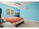 Bright bedroom with colorful comforter, ceiling fan, and large window at 149 Harmony Ln., Myrtle Beach, SC 29588