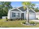 Well-maintained home featuring a palm tree, front lawn landscaping, and a welcoming entrance at 149 Harmony Ln., Myrtle Beach, SC 29588