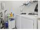 Laundry room featuring a white washer and dryer with storage shelves and cleaning supplies at 149 Harmony Ln., Myrtle Beach, SC 29588