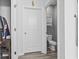 Toilet room with a white door, grey walls, with a wall mounted cabinet above toilet at 149 Harmony Ln., Myrtle Beach, SC 29588