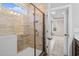 Walk-in shower featuring decorative tile and a glass door at 5032 Cambria Ct., Little River, SC 29566