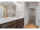 Bathroom with a double vanity, warm wood cabinets, and a tiled shower enclosure at 5032 Cambria Ct., Little River, SC 29566