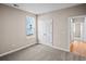 Spacious carpeted bedroom with double doors and a window offering serene outside views at 5032 Cambria Ct., Little River, SC 29566