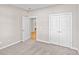 Inviting carpeted bedroom with open closet space and hardwood floors, perfect for relaxation at 5032 Cambria Ct., Little River, SC 29566